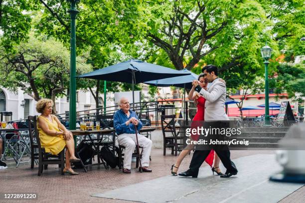 senior couple watching expert argentine tango dancers - tango argentina stock pictures, royalty-free photos & images