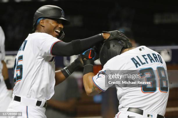 Jorge Alfaro of the Miami Marlins celebrates with Lewis Brinson after hitting a two-run home run during the third inning against the Boston Red Sox...