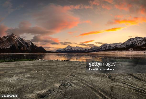 abraham lake in sunrise in winter - diry track stock pictures, royalty-free photos & images