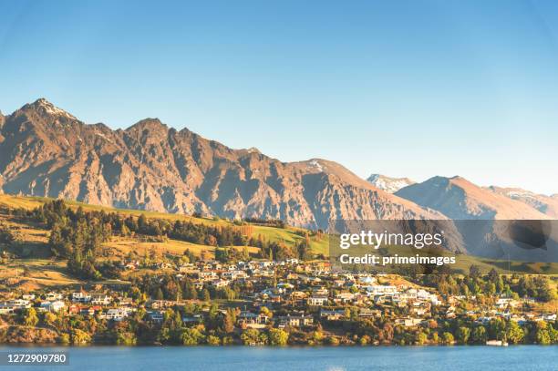 sunset view of queenstown and lake wakatipu from apartment,house at sunset queenstown south island new zealand - queenstown stock pictures, royalty-free photos & images