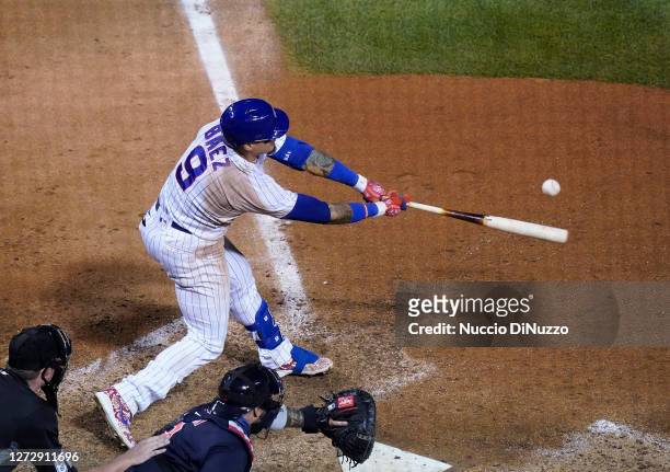 Javier Baez of the Chicago Cubs hits a walk off RBI single during the tenth inning of a game against the Cleveland Indians at Wrigley Field on...