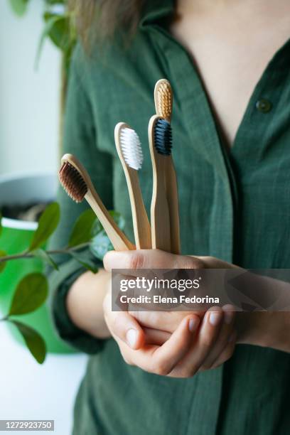 a woman with a bamboo toothbrushes - toothbrush pattern stock pictures, royalty-free photos & images