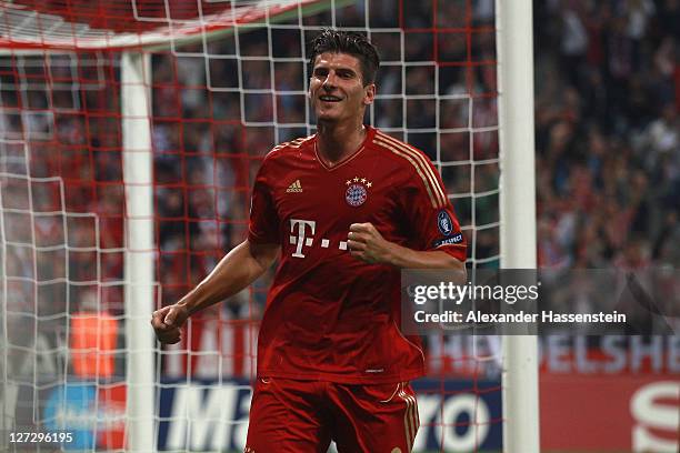 Mario Gomez of Muenchen celebrates scoring the second team goal during the UEFA Champions League group A match between FC Bayern Muenchen and...