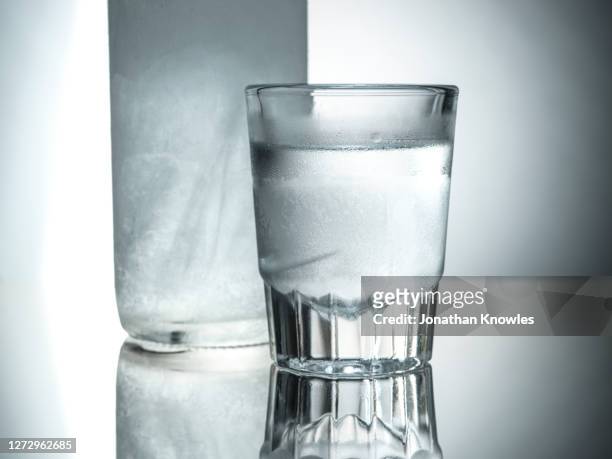 close up vodka in shot glass - ウォッカ ストックフォトと画像