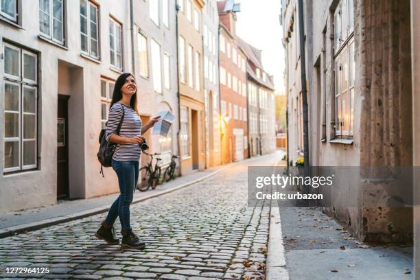 woman exploring lubeck old town - lübeck stock pictures, royalty-free photos & images