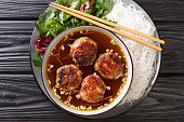 Bun cha Hanoi is a delicious Vietnamese street food combining flavorful meatballs, rice noodles and dipping sauce. Horizontal top view
