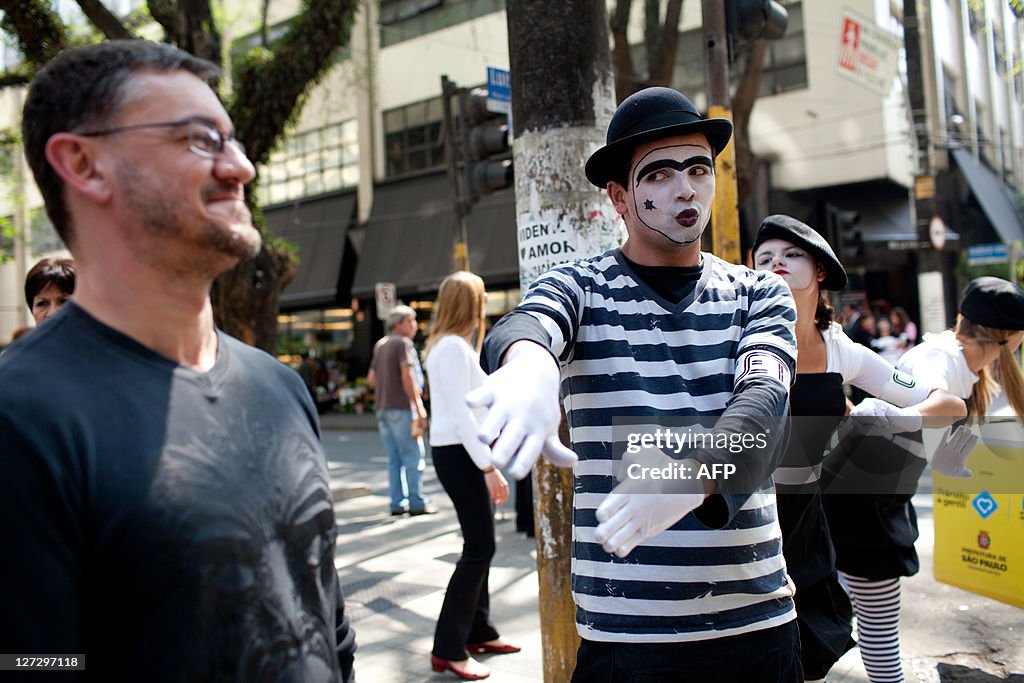 Mimes urge pedestrians to obey the trafi