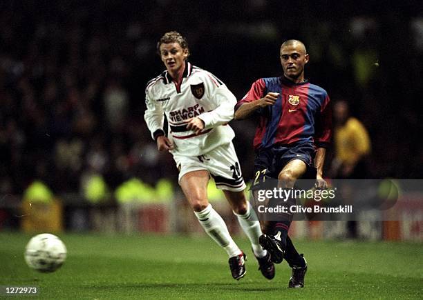 Luis Enrique of Barcelona is followed by Ole Gunnar Solskjaer of Manchester United during the Champions League match at Old Trafford in Manchester,...