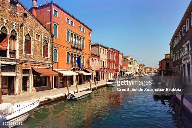 view from a bridge of a street and its canal on the beautiful island of murano - murano fotografías e imágenes de stock