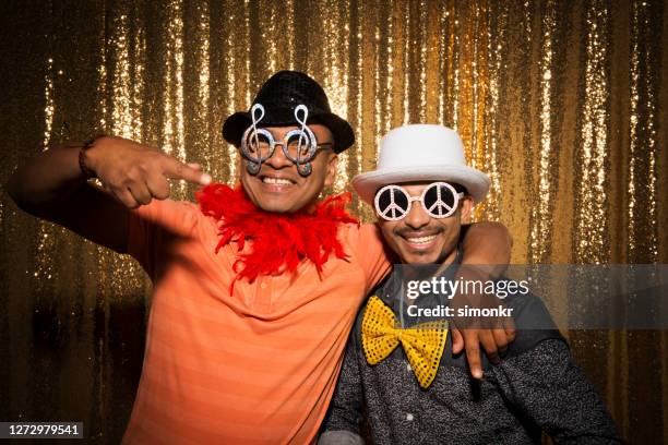 portrait of friends enjoying at party - feather boa stock pictures, royalty-free photos & images