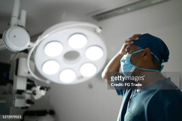 worried healthcare male nurse at operating room in hospital - mistaken identity stock pictures, royalty-free photos & images