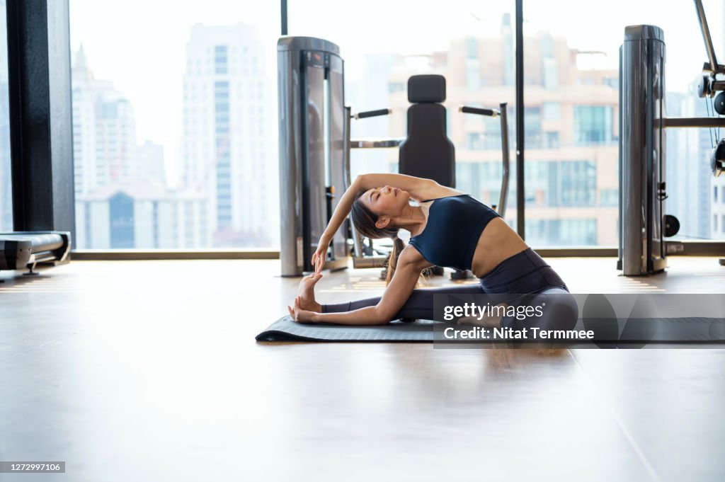 Healthy Women practicing advance yoga lesson in health club. Health lifestyle, Body Improvement.