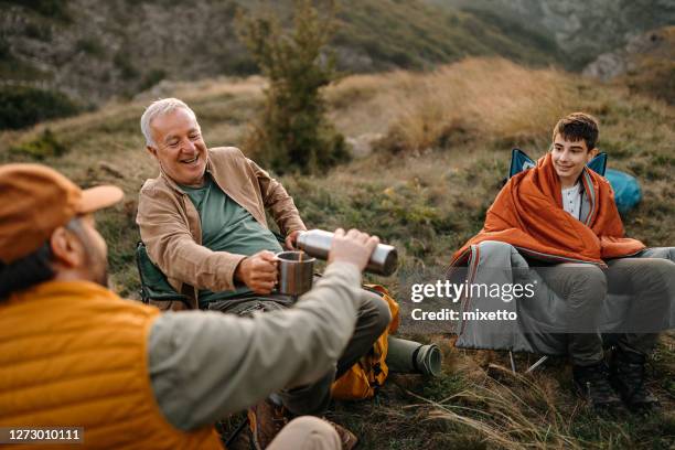 three generations males drinking coffee on a picnic - drinks flask stock pictures, royalty-free photos & images