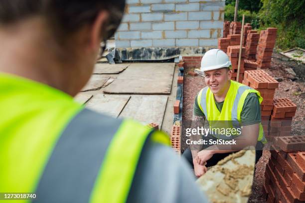 female construction worker at work - builder apprenticeship stock pictures, royalty-free photos & images