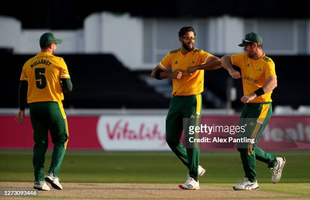 Ben Duckett of Notts Outlaws celebrates with teammate Imad Wasim after taking the catch of Wayne Madsen of Derbyshire Falcons during the T20 Vitality...