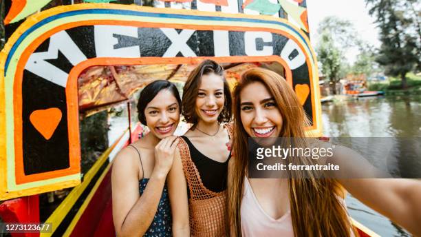 girlfriends visiting mexico - xochimilco stock pictures, royalty-free photos & images