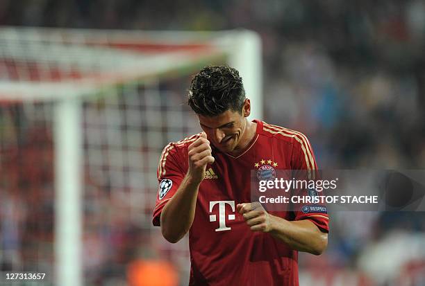 Bayern Munich's striker Mario Gomez celebrates after scoring the 2-0 during the Champions League group A match of German first division football club...