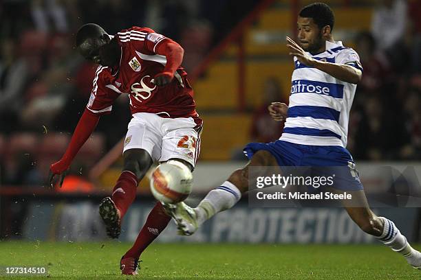 Albert Adomah of Bristol City shoots as Jobi McAnuff challenges during the npower Championship match between Bristol City and Reading at Ashton Gate...