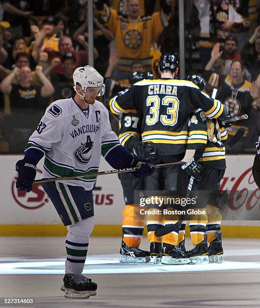 Game Four of the Stanley Cup Finals, Bruins surround Brad Marchand after his 2nd period goal, putting the Bruins ahead 3-0 as Vancouver Henrik Sedin...