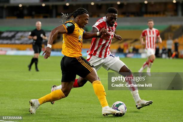 Adama Traore of Wolverhampton Wanderers is put under pressure by Bruno Martins Indi of Stoke City during the Carabao Cup second round match between...