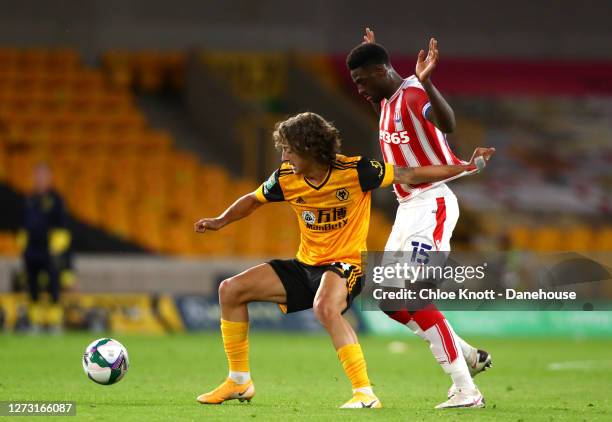 Fabio Silva of Wolverhampton Wanderers and Bruno Martins Indi of Stoke City in action during the Carabao Cup Second Round match between Wolverhampton...