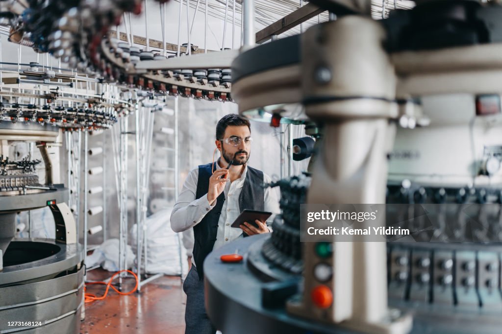 Small Business owner checking the machines performance