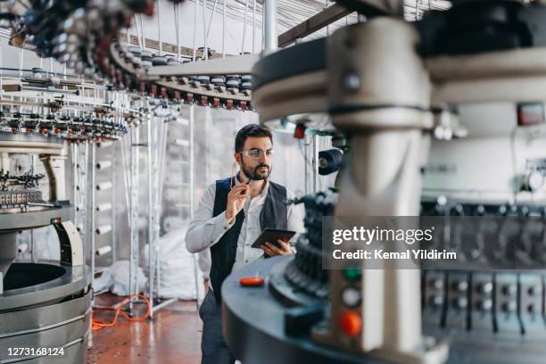 small business owner checking the machines performance - textile worker stock pictures, royalty-free photos & images