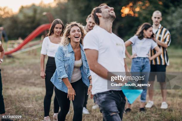 groep vrienden die pret op teambouw in aard hebben - teambuilding stockfoto's en -beelden