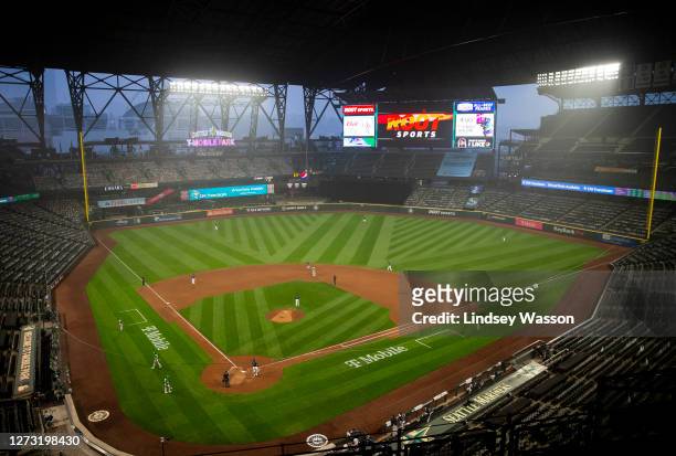 Wildfire smoke glows against stadium lights as the Seattle Mariners and Oakland Athletics play in the second game of a doubleheader at T-Mobile Park...