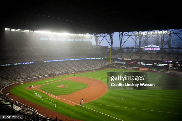 Wildfire smoke glows against stadium lights as the Seattle Mariners and Oakland Athletics play in the second game of a doubleheader at T-Mobile Park...