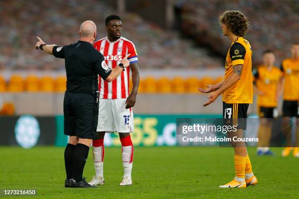 Referee Simon Hooper intervenes following an argument between Bruno Martins Indi of Stoke City and Fabio Silva of Wolverhampton Wanderers during the...