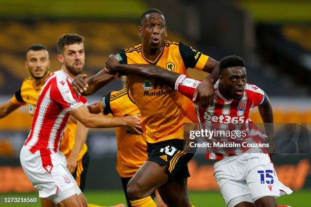 Willy Boly of Wolverhampton Wanderers tangles with Nathan Collins and Bruno Martins Indi of Stoke City during the Carabao Cup Second Round game...