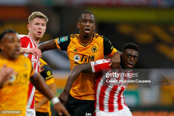 Willy Boly of Wolverhampton Wanderers tangles with Nathan Collins and Bruno Martins Indi of Stoke City during the Carabao Cup Second Round game...