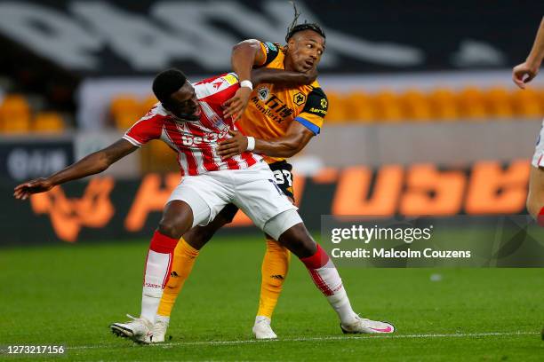 Bruno Martins Indi of Stoke City competes with Adama Traore of Wolverhampton Wanderers during the Carabao Cup Second Round game between Wolverhampton...
