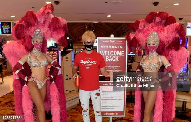 Magician/comedian Murray SawChuck poses with showgirls Ciara Cornett and Kaleigh Jones at the main entrance to the Tropicana Las Vegas after the Las...