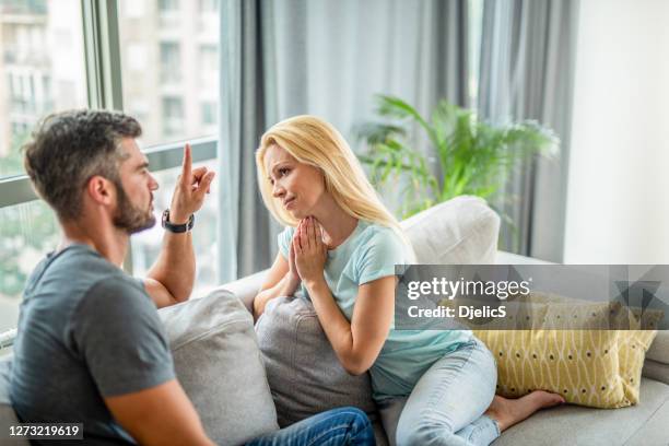 mid adult woman apologizing to her boyfriend. - bequest stock pictures, royalty-free photos & images