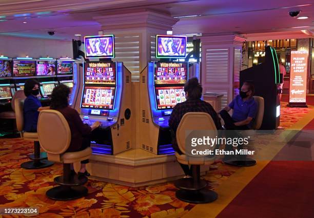 Guests play slot machines at the Tropicana Las Vegas after the Las Vegas Strip resort reopened for the first time since mid-March because of the...