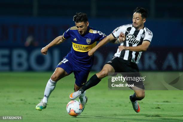 Eduardo Salvio of Boca Juniors fights for the ball with Ivan Piris of Libertad during a group H match of Copa CONMEBOL Libertadores 2020 between...