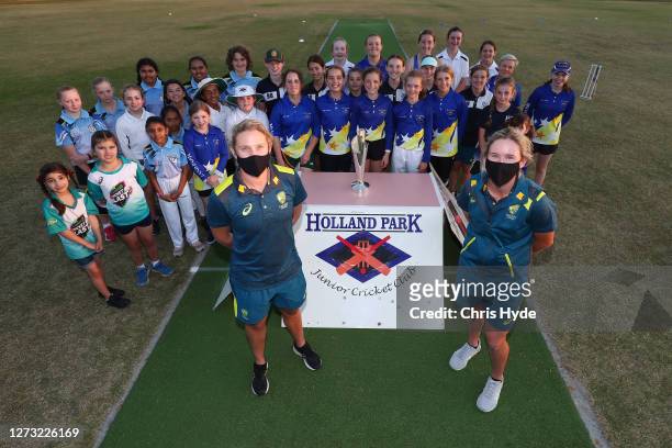 Delissa Kimmince and Beth Mooney pose with the Cricket Australia Women's World Cup Trophy at Holland Park Junior Cricket Club on September 16, 2020...