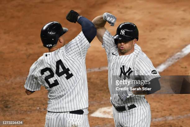 Brett Gardner celebrates with Gary Sanchez of the New York Yankees after Gardner hit a two-run home run during the fourth inning against the Toronto...