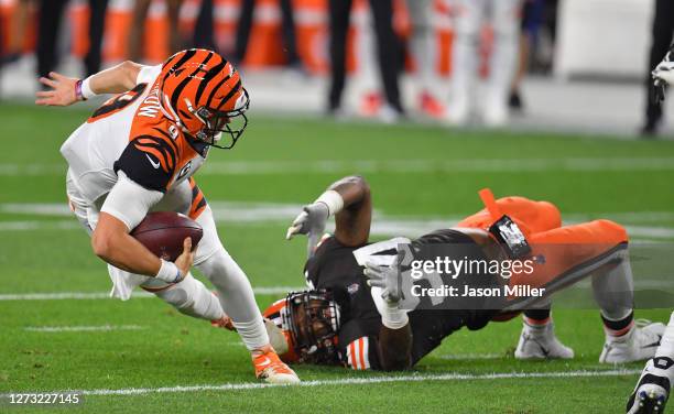 Joe Burrow of the Cincinnati Bengals is sacked by Adrian Clayborn of the Cleveland Browns during the first quarter at FirstEnergy Stadium on...