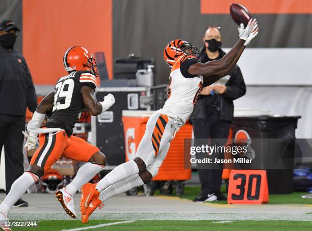 Green of the Cincinnati Bengals attempts a reception against Terrance Mitchell of the Cleveland Browns during the first quarter at FirstEnergy...