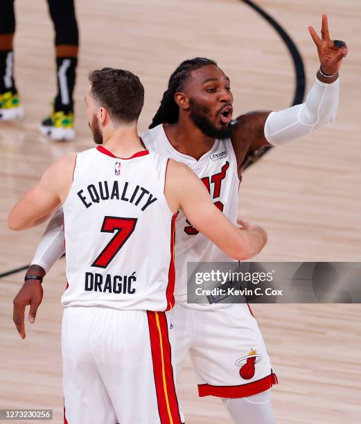 Jae Crowder of the Miami Heat and Goran Dragic of the Miami Heat react after their win over Boston Celtics in Game Two of the Eastern Conference...