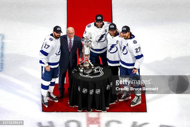 Bill Daly, the deputy commissioner and chief legal officer of the National Hockey League presents the Prince of Wales Trophy to captains Alex...