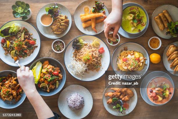 eating thai cusines. - thai culture stock pictures, royalty-free photos & images