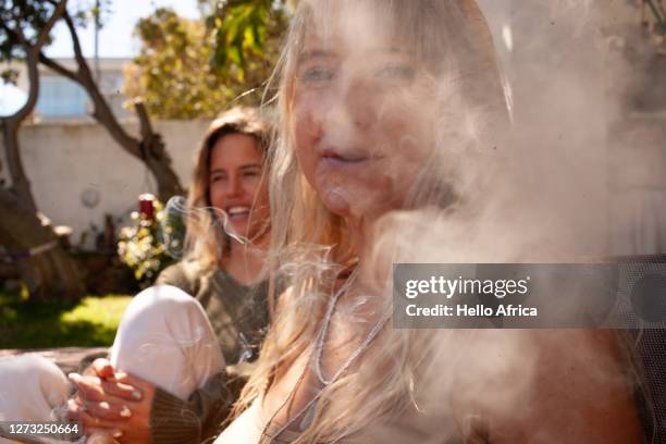 a beautiful young lad friend smoking up a storm - friends smoking stock pictures, royalty-free photos & images