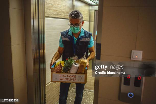 food delivering at home address - social distancing elevator stock pictures, royalty-free photos & images
