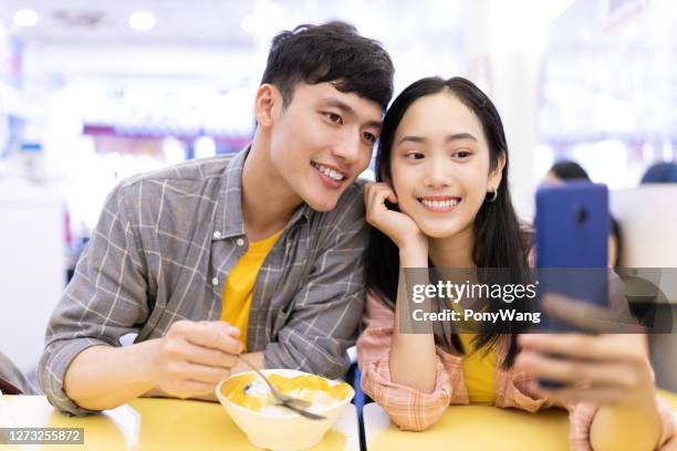 couple eat mango shaved ice - mango shaved ice stock pictures, royalty-free photos & images