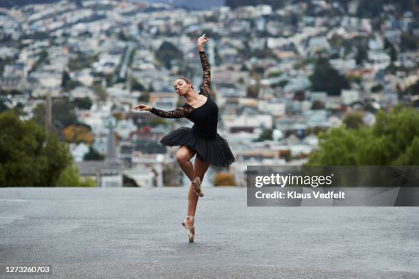 young ballet dancer dancing on street - balletttänzer stock-fotos und bilder