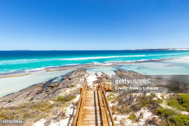 the amazing beaches in esperance, with shallow water, blue sky, blue colors of indian ocean and rocks - australia occidental fotografías e imágenes de stock